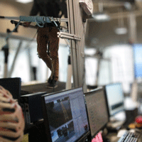 Person walking motion-tracking treadmill in lab