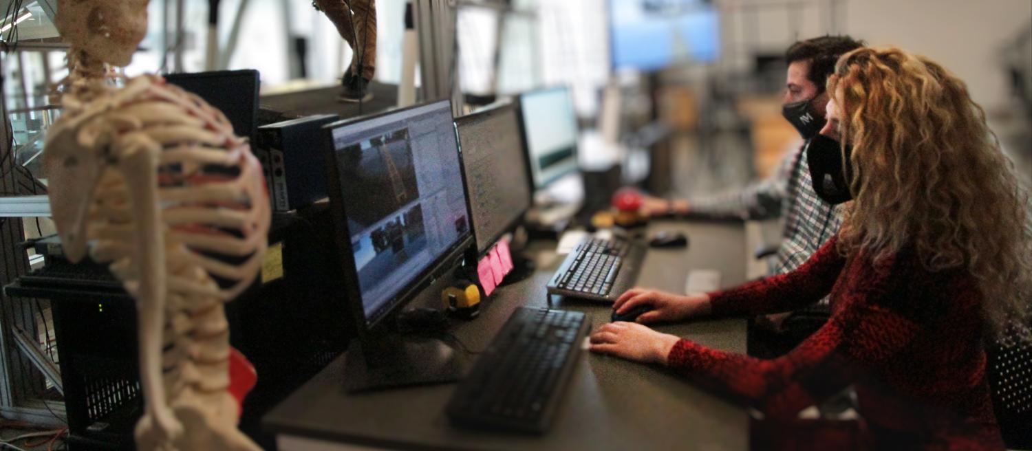 Technicians monitoring software during treadmill experiment in INSL