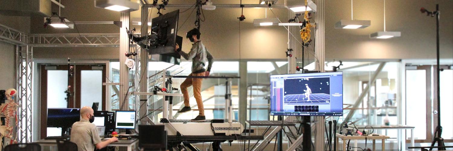 Technicians monitoring software during treadmill experiment in INSL