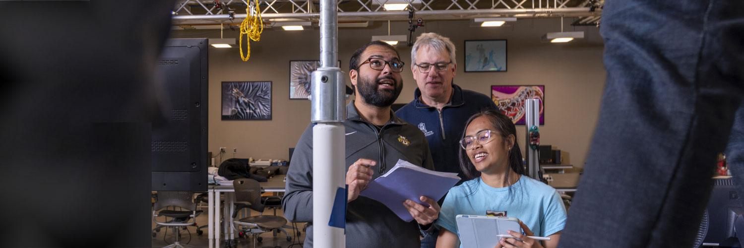 Ricardo Vega and Dr. Brian Schmit work in Engineering Hall, Marquette University