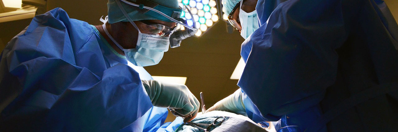 Physicians bent over patient during procedure