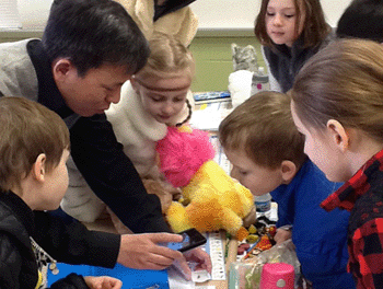 Dr. Yu demonstrates photographing the wings of a bug at Ellsworth Hills Elementary School. 