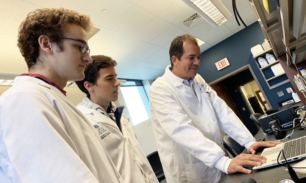 Dr. Brandon Tefft working with students in the Cardiovascular Regenerative Engineering Laboratory
