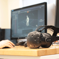Virtual reality hardware with computer screen showing human walking