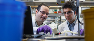 Dr. Guilherme Garcia working in lab with student