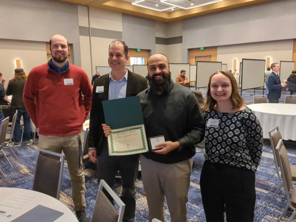 Shashanka Rao and CaRE Lab members pose with award