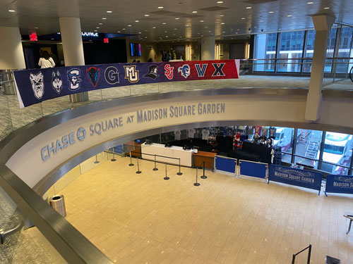 Lobby at Madison Square Garden decorated with banners from participating schools, including Marquette 