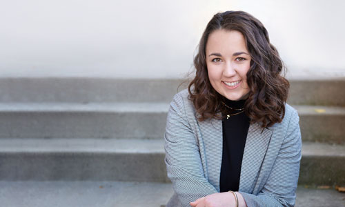 Elise Raschke poses sitting on steps