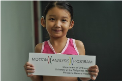 Young girl holding sign that reads "Motion Analysis Program"